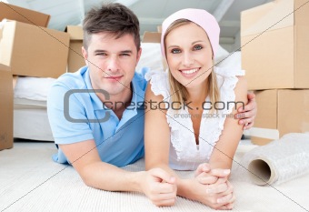 Jolly couple lying between boxes 