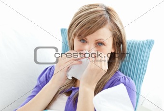 Portrait of a sick pretty woman blowing
