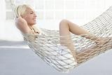 beautiful blonde young girl relaxed on hammock profile 