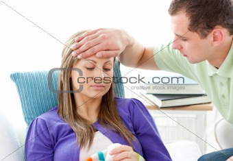 Sick woman lying on a sofa worried boyfriend feel her temperatur
