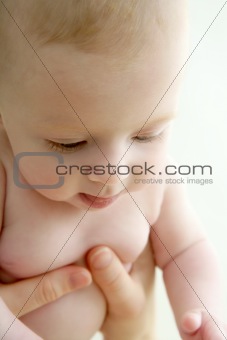 baby nude blond on mother arms