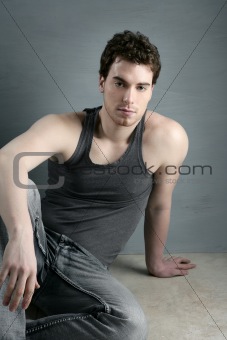 casual young man portrait sit over gray