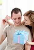 Smiling woman giving a present to her boyfriend 