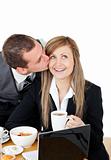 Attractive businessman kissing his bright girlfriend