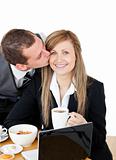 Young businessman kissing his delighted girlfriend