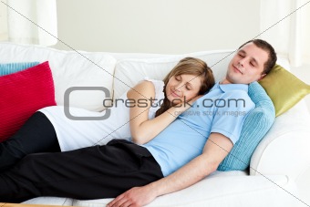 Loving couple sleeping lying on a sofa  
