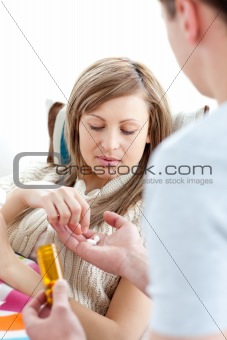 Boyfriend giving his sick girlfriend pills