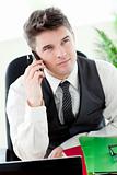 Smiling young businessman talking on phone