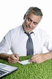 senior businessman sign check green grass