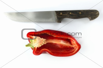 Red pepper and kitchen knife over white