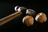 Two walnuts and old aged hammer