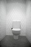 toilet in a white room diamond shape tiles 
