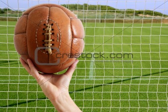 Football ball in hand net soccer goal