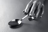 gray silver hand and spoon futuristic food