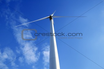 Electric wind mill viewed from the floor over blue sky