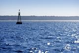Beacon floating on blue ocean as guide help