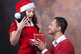 happy young couple with christmas clothes and gift