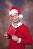 happy young man with christmas clothes and gift