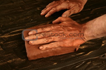 artist man hands working red clay for handcraft