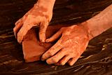 artist man hands working red clay for handcraft