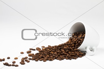 coffee beans falling from coffee cup
