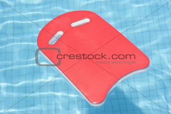 A red float floating in blue pool