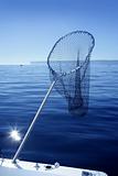 Fishing scoop net on boat in blue sea