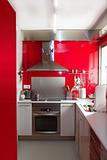home kitchen in red colors natural window light