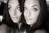 Beautiful woman on the mirror as a twins portrait