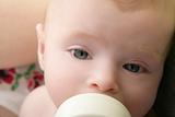Baby blond little girl feeding drinking milk