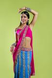 Beautiful indian young brunette woman dancing