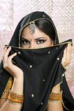Beautiful brunette asian girl with black veil on face