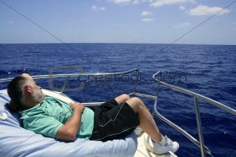 Sailor senior man having a rest on summer boat
