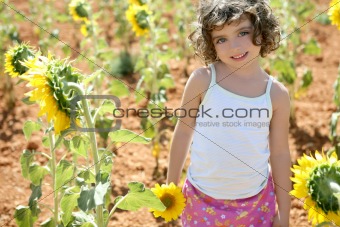 Beautiful little girl in a summer sunflower field