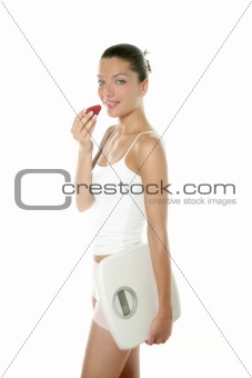 Beautiful woman eating a red strawberry
