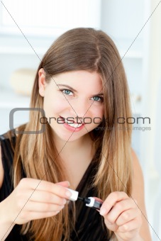 Teen woman putting make-up on her face