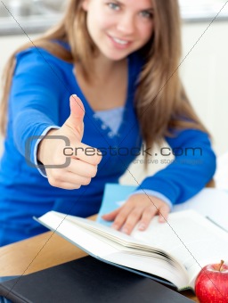 Motivated woman reading a book thumb up