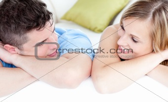 United couple looking at the camera on a sofa