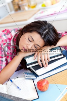 Close-up of a tired caucasian teen girl studying 