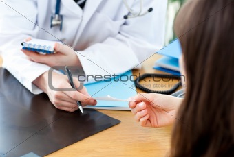 A doctor giving his patient a prescription in his office