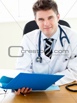 Smiling young doctor holding a folder
