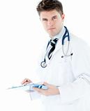 Handsome male doctor with clipboard looking at the camera