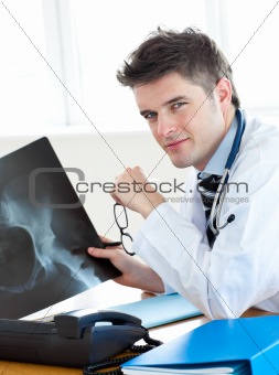 Smiling doctor showing his female patient a x-ray