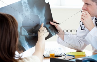 Male doctor showing his female patient a x-ray