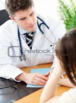 Caring male doctor holding the hand of his female patient