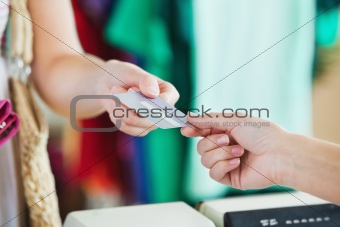 Close-up of a woman paying with her credit card 
