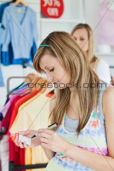 Happy women choosing clothes together