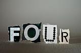 Torn Letters Spelling Out FOUR