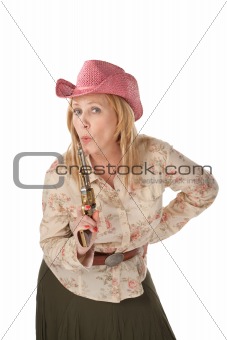 Cowgirl on white background with a recently used pistol