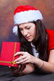 young girl in red with christmas clothes and gift box